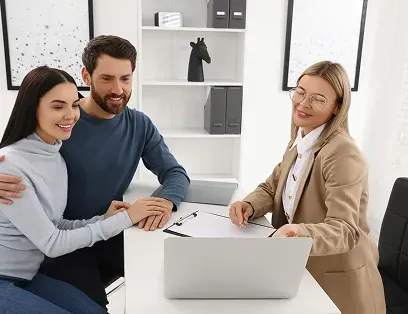 A policyholder and an adviser at a desk