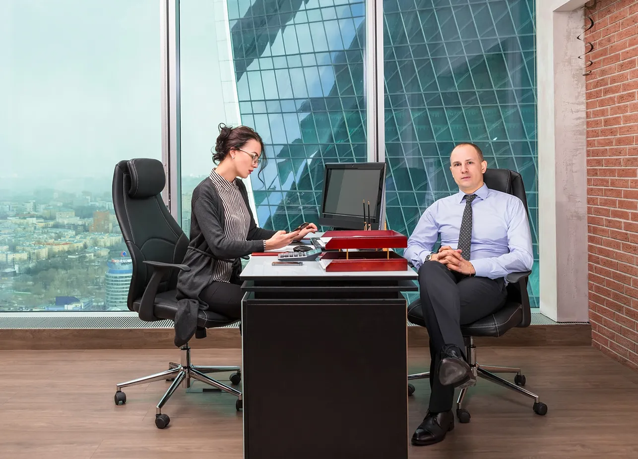 Three advisers reviewing a claim file in a meeting room