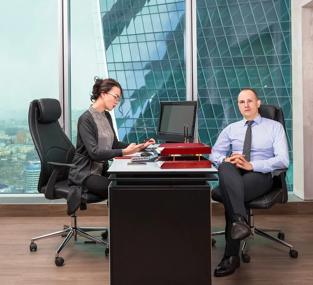 An adviser and a client at a desk
