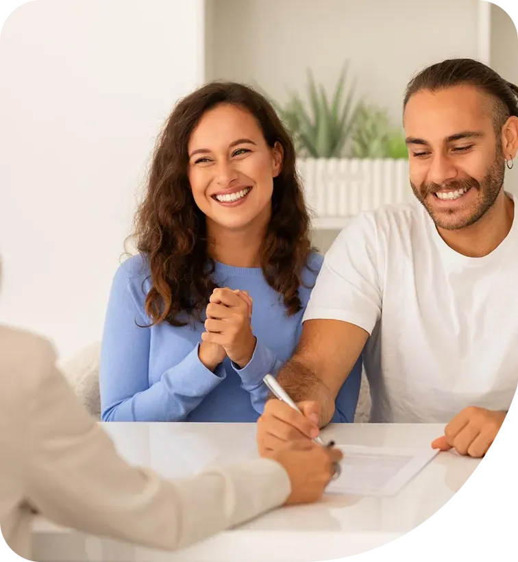An adviser going through a policy schedule with a couple at a kitchen table